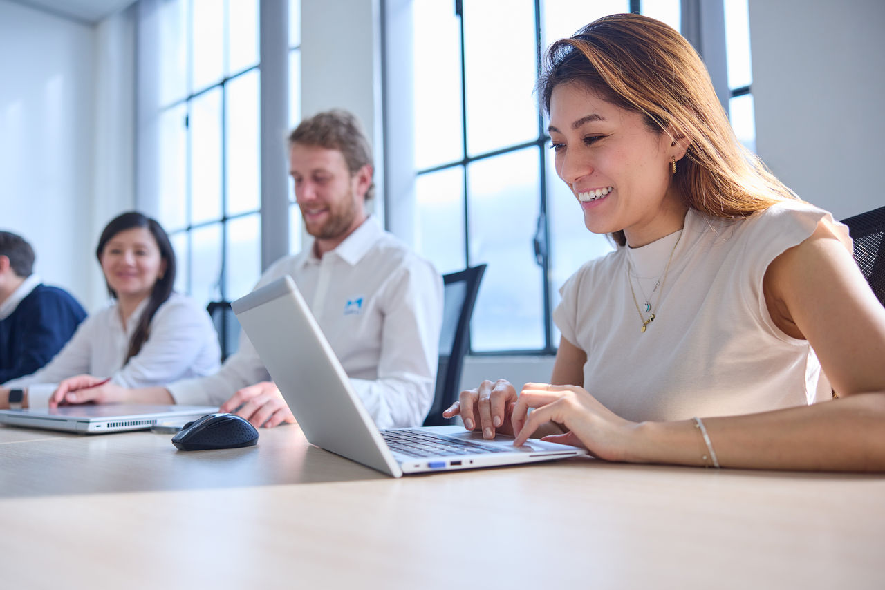 Employees working at a table with computers