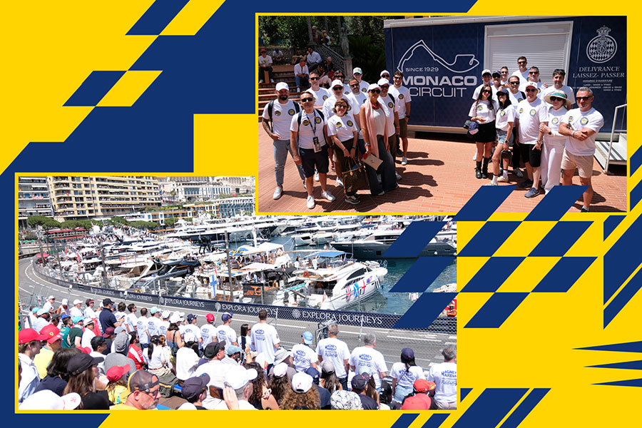 Magneti Marelli Parts & Services clients and partners at the Monaco Formula 1 Grand Prix: group photo in the Monaco Circuit area, with participants in the grandstand overlooking the track and the harbour.